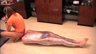 Nasty mistress tied up her slave with a plastic foil