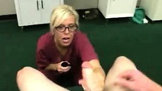Milf Carey Riley strokes a young guys dick in the office