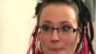 Tattooed chick moans while a mistress hits her with a whip