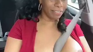 Solo ebony Desiree Desire shows her tits while driving