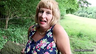 Granny plays with her pussy outdoor