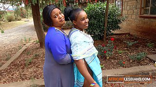 Mature married African lesbians kiss in public during a block party
