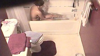 Voyeur video of a naked girl bathing