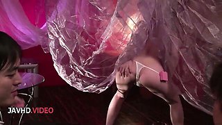 She gives blowjob in dark purple-lit shadowy bedroom