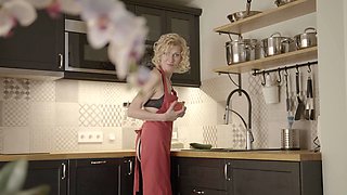 Mature blonde Peggy seductively strokes her wet pussy in sheer lacy lingerie