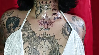 Tattooed Latin woman, black heels plays modeling